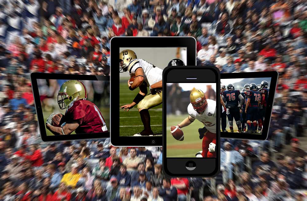 cell phones with photos of footballs players superimposed on a crowd of sports fans