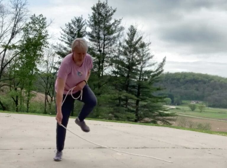 Cindy Kuhrasch jumping over a rope outside