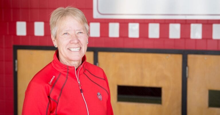 Cindy Kuhrasch with a Badger red jacket and a big smile