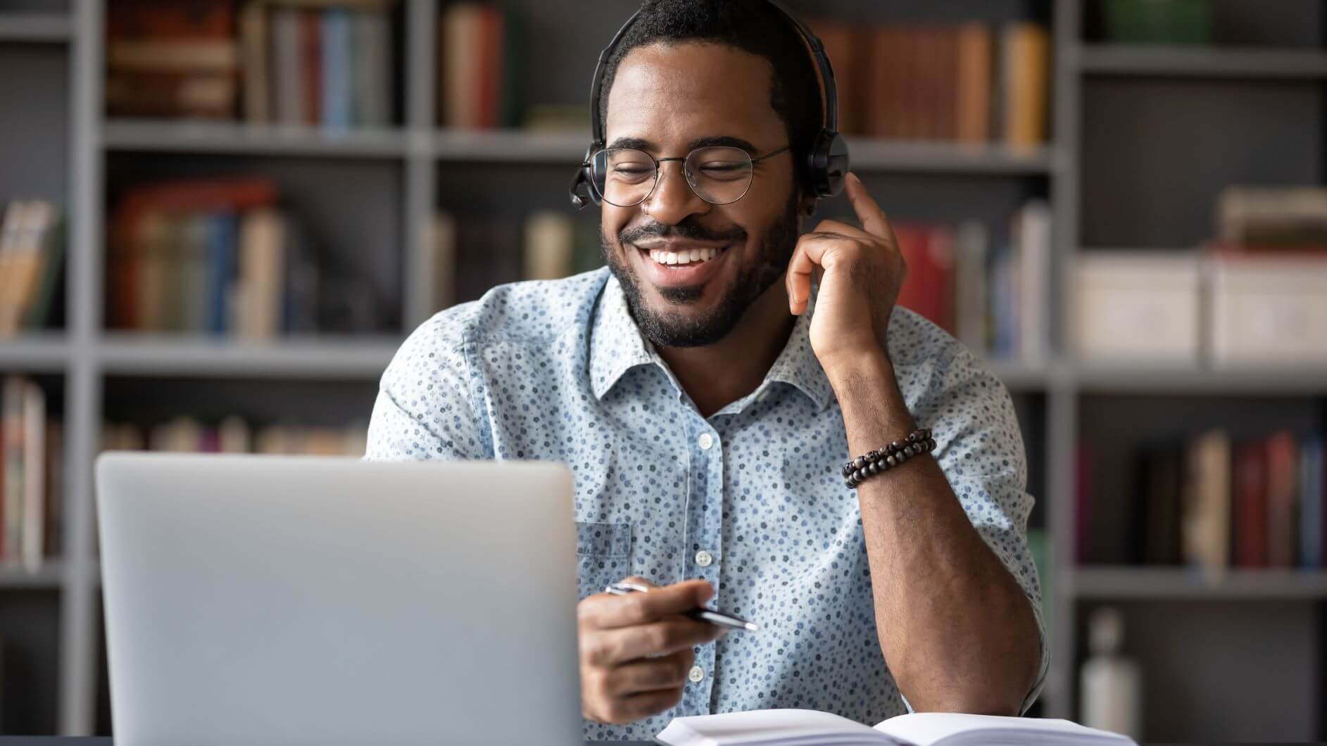 Man looking at labtop screen and smiling