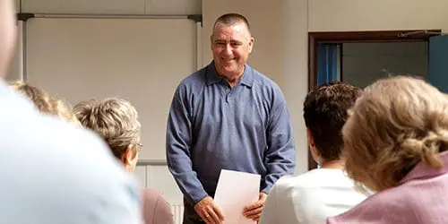 A student presents in front of class