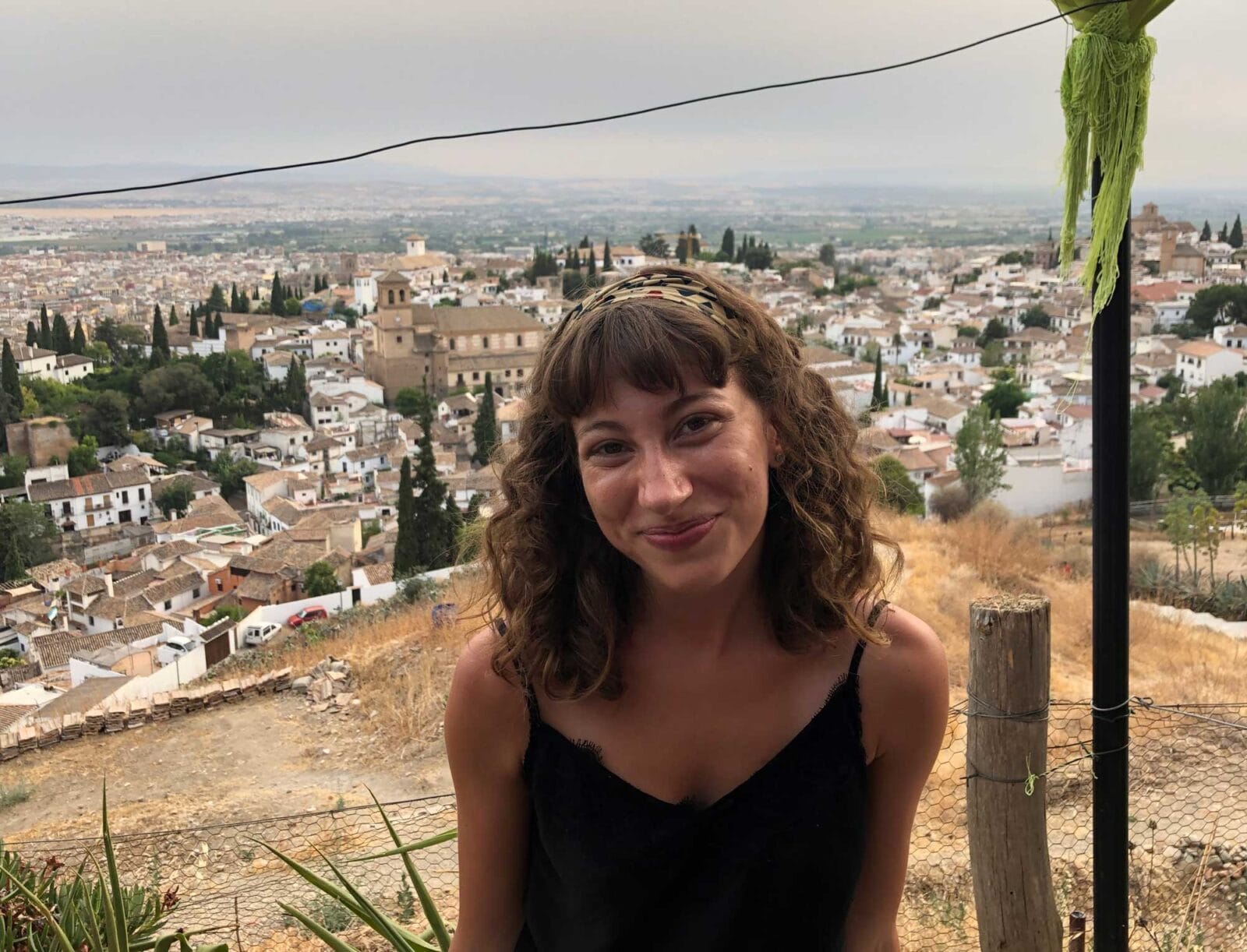 Sarah Candee sitting down with backdrop of a city