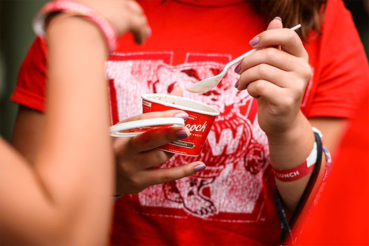 Person holding a spoon and ice cream cup from Babcock Ice Cream