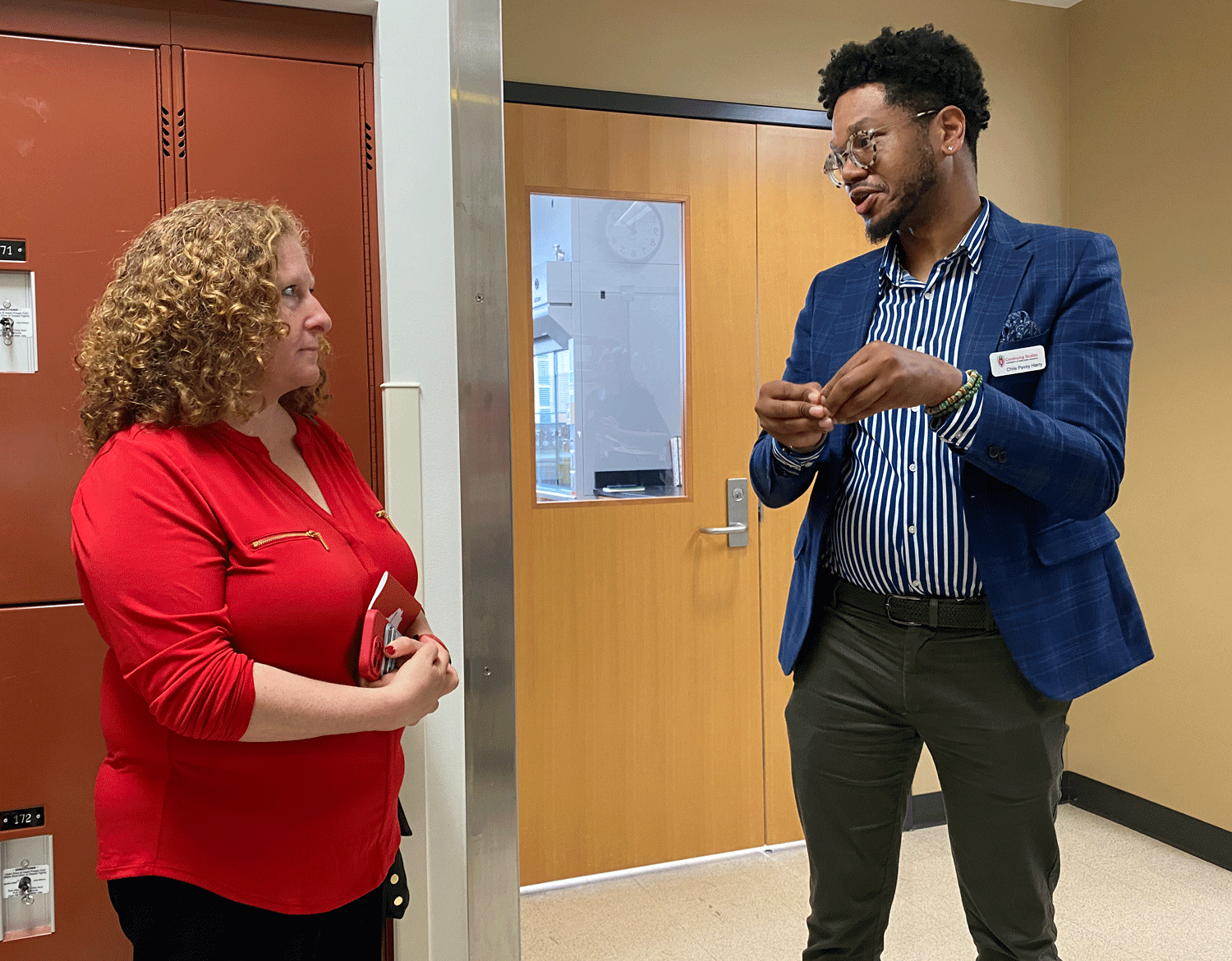 Chancellor Jennifer Mnookin standing and talking with Chris Pevey Harry