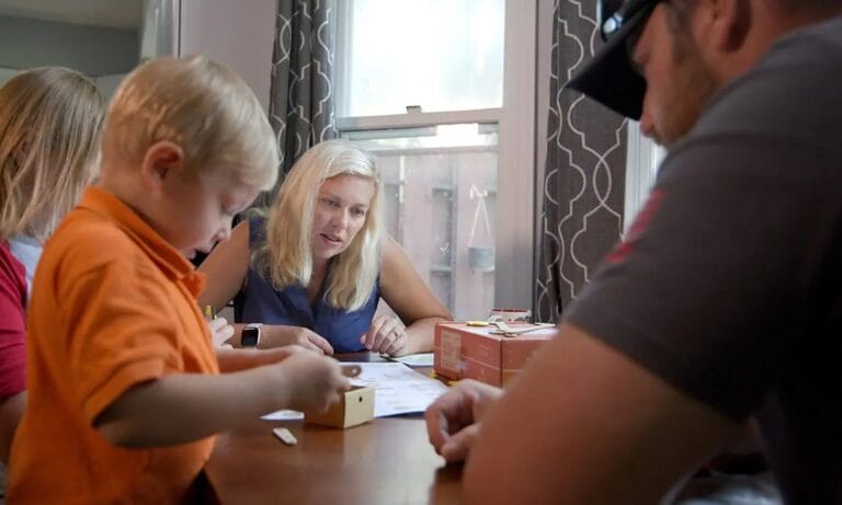 Kristy and her family looking over her coursework