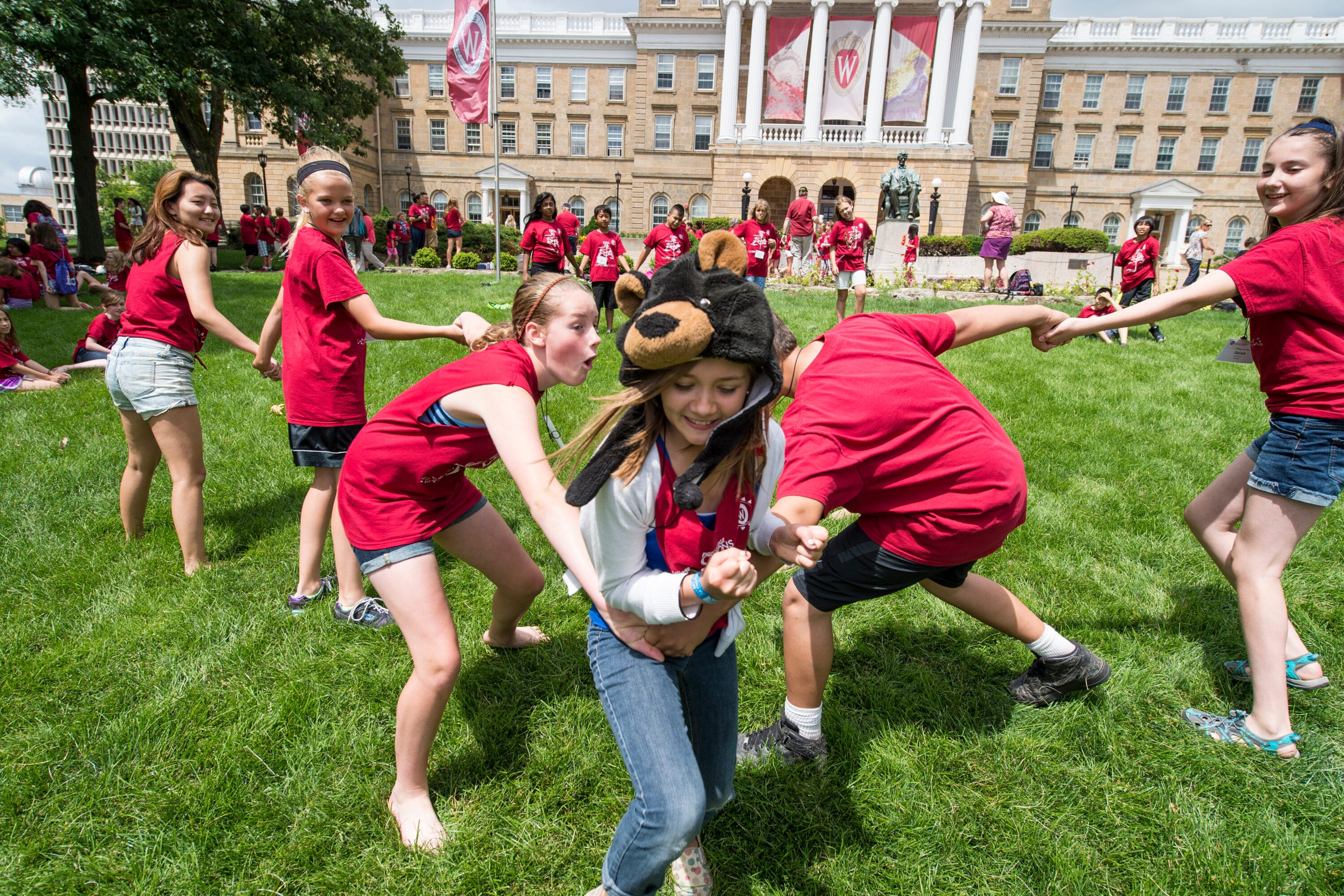 Precollege students playing in the field of Bascom Hill