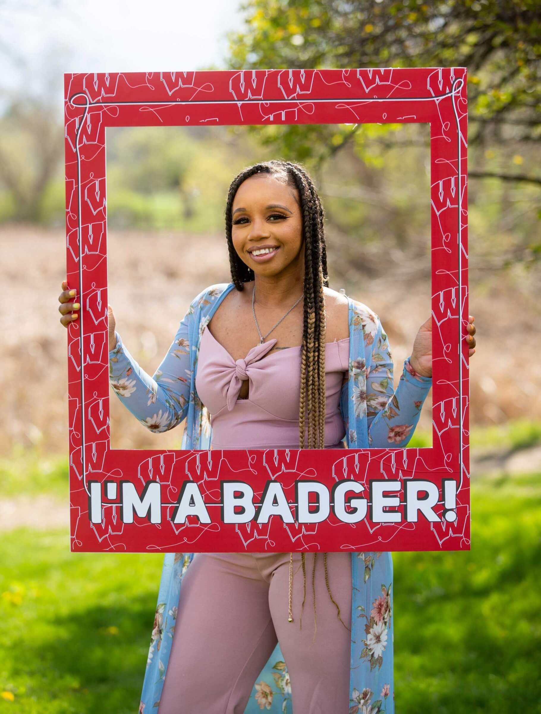 Student Kewiana Pollard smiling and looking through a Badger picture frame