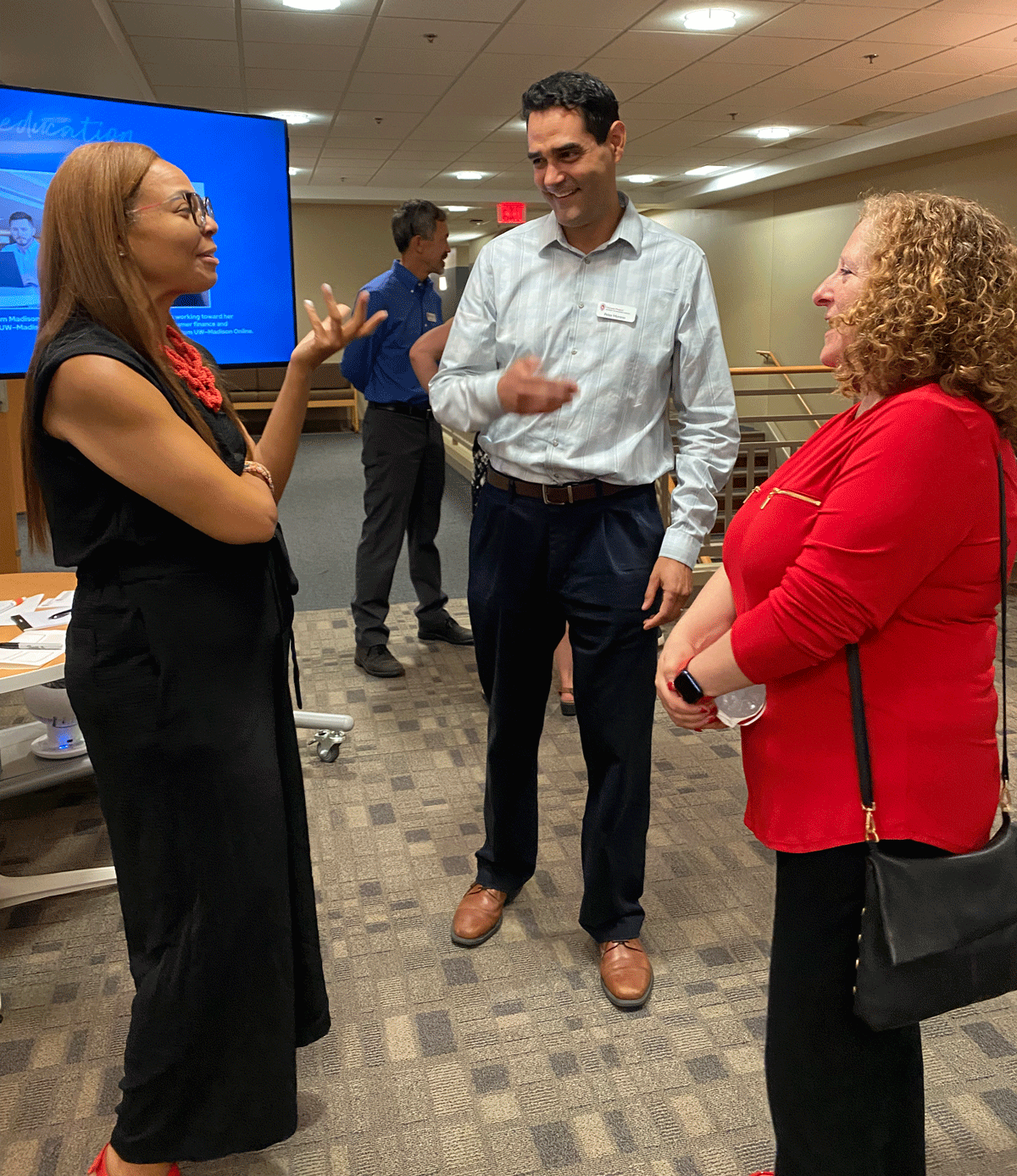 Chancellor Mnookin talking with two staff people at DCS offices