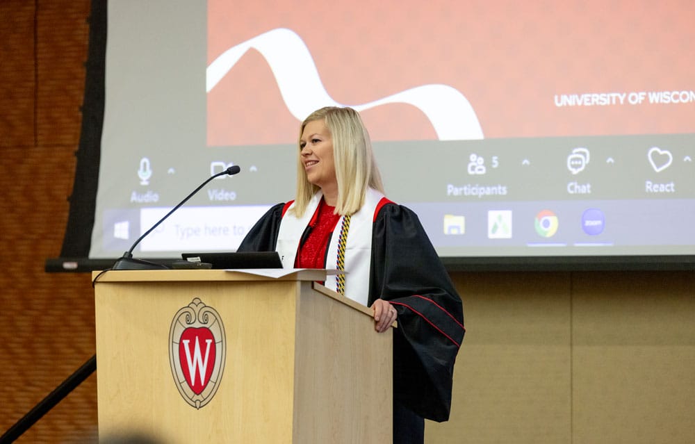 Kristy speaking at the podium