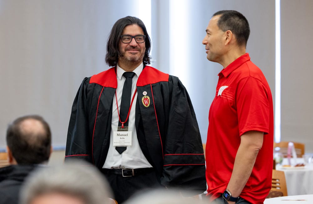 Manny wearing his graduation gown