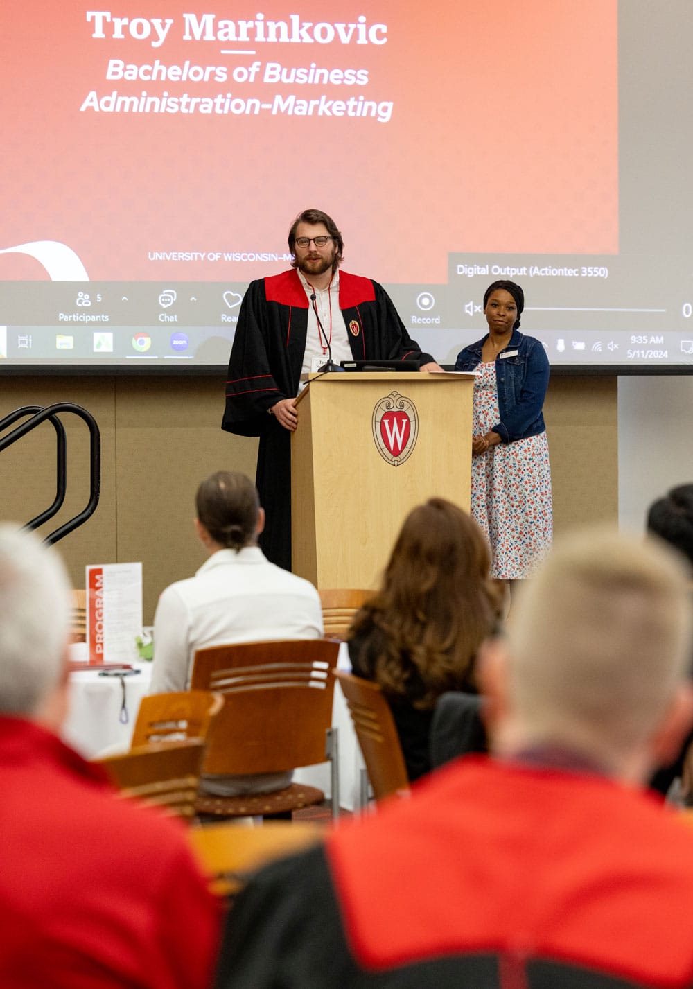 Troy speaking at the podium