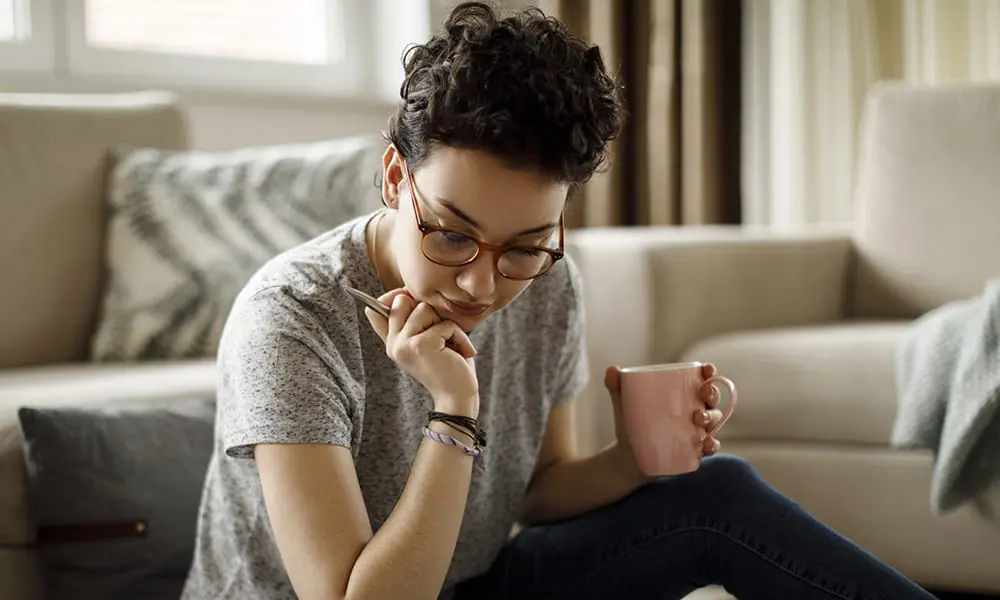 a woman studying in her living room