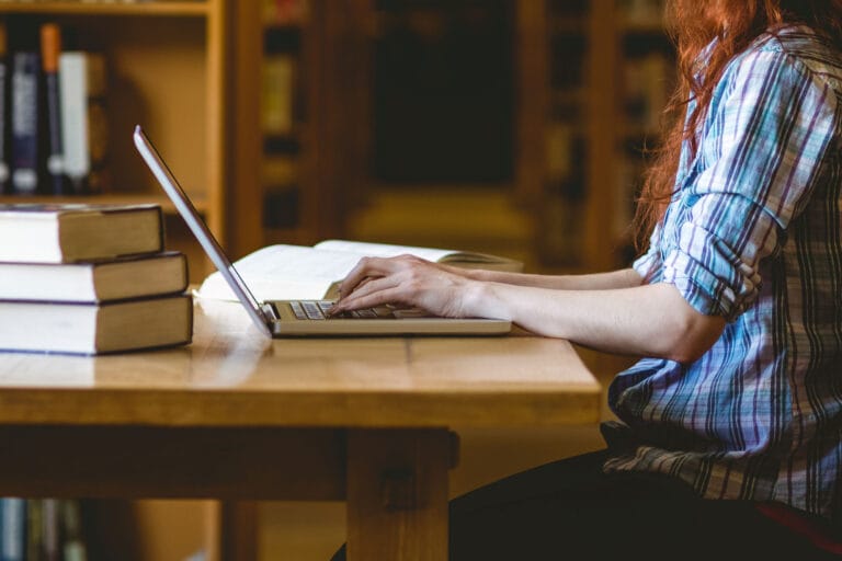 Woman working on a laptop in a library