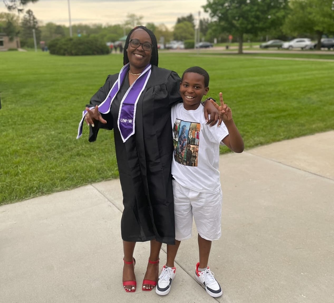 Chikara Crooks in her cap and gown, posing for a photo with her son.