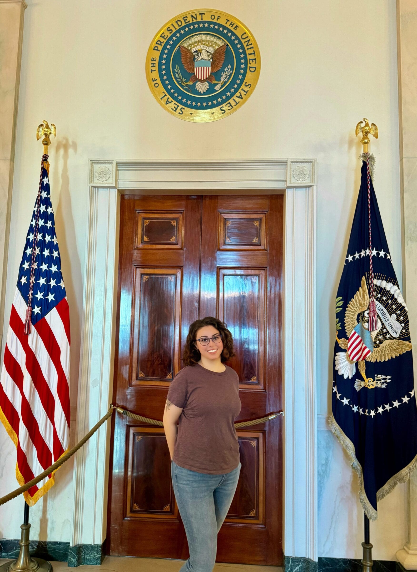 Ivanna Ceballos posing between two flags