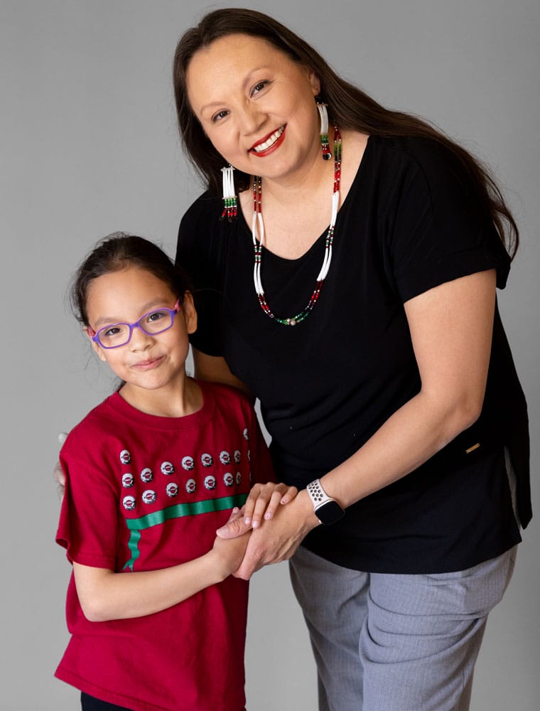 Yolanda Pushetonequa posing with her child for a photo