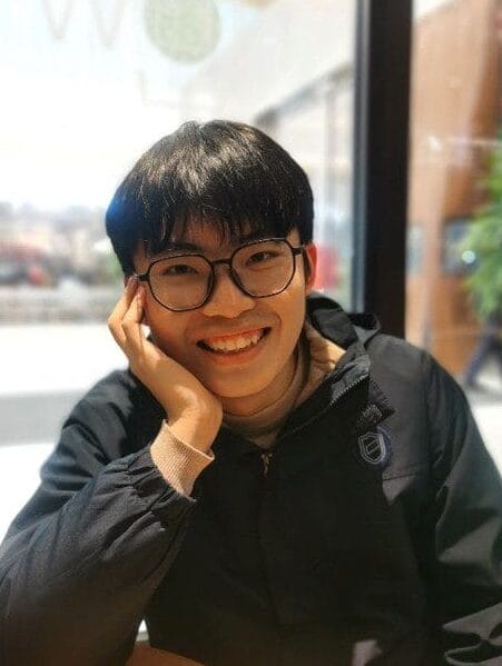 Chentian smiling, sitting in a cafe