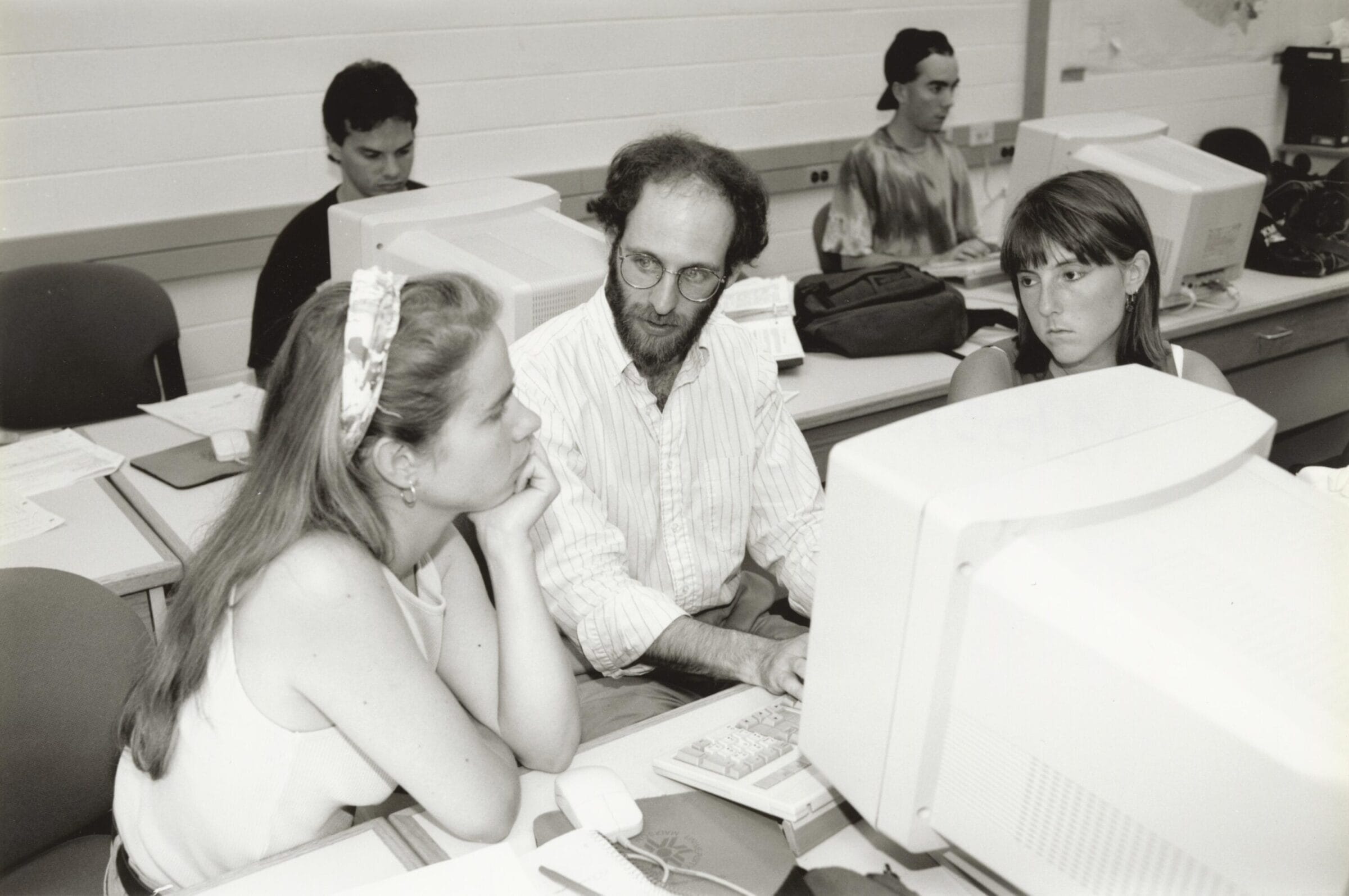 A trio of students sitting in front of a computer.