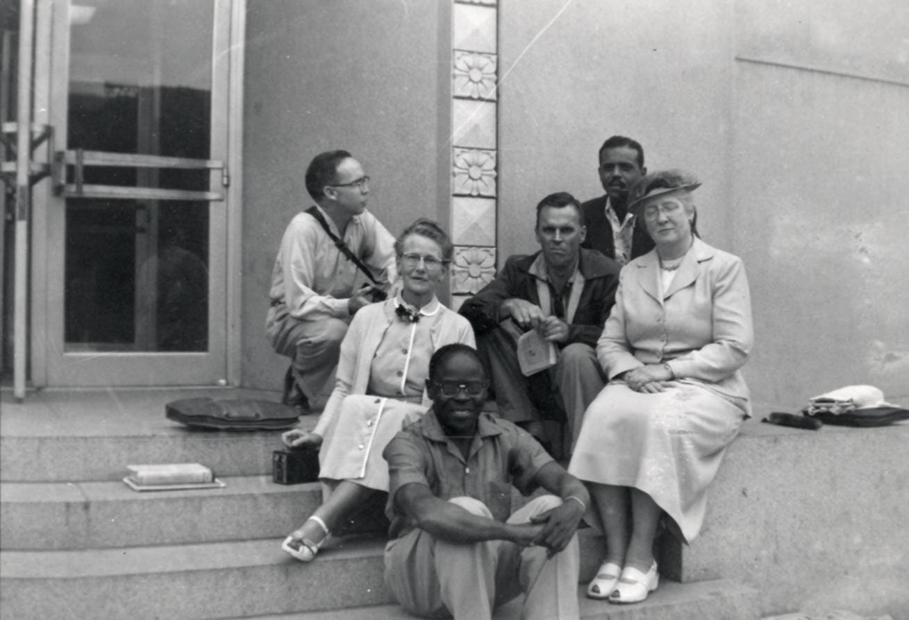 A group of students and their professor posing for a group photo.
