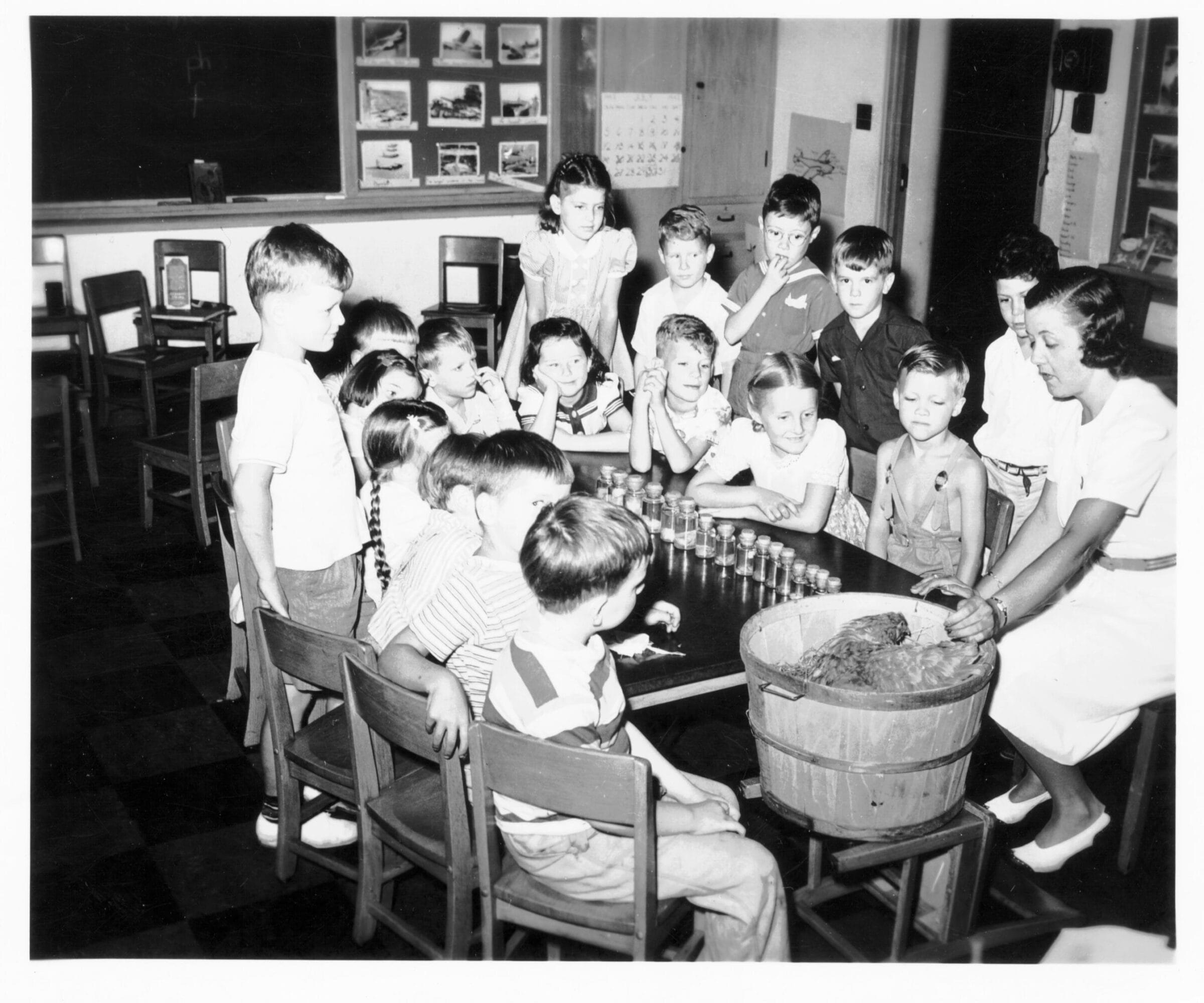 A group of school kinds with their teacher working on an assignment.