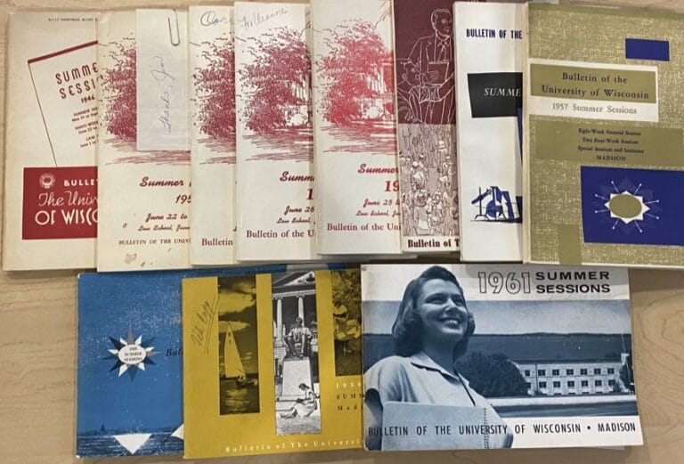 A series of photographs and postcards spread out on a table