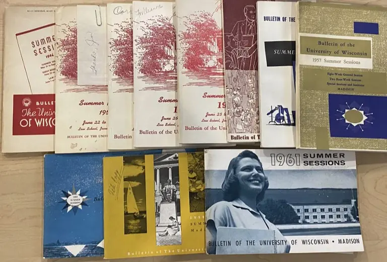 A series of photographs and postcards spread out on a table