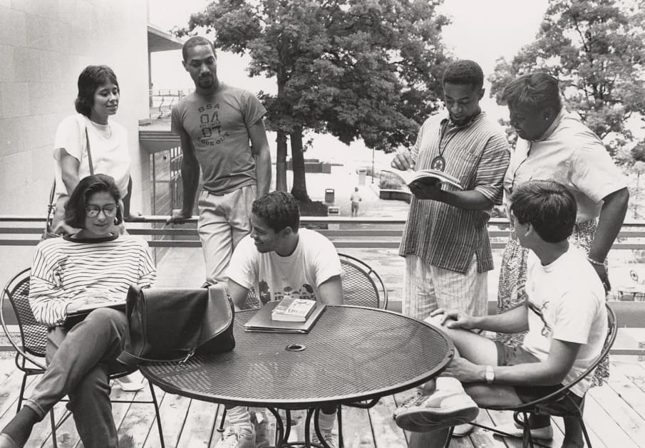 A group of students around a table, studying.