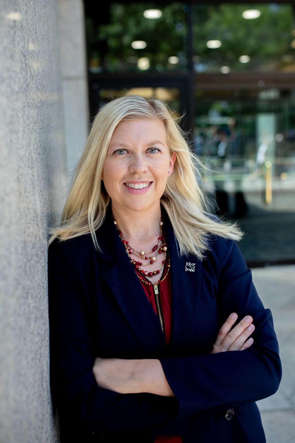 Kristy Jorgensen posing for a picture in front of a government building