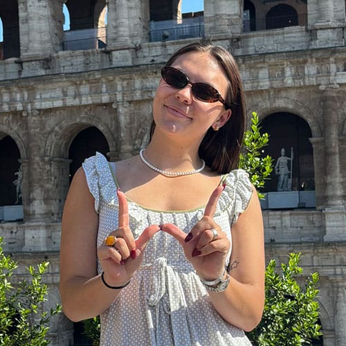 Student Morgan Ramsey posing in front of the colosseum