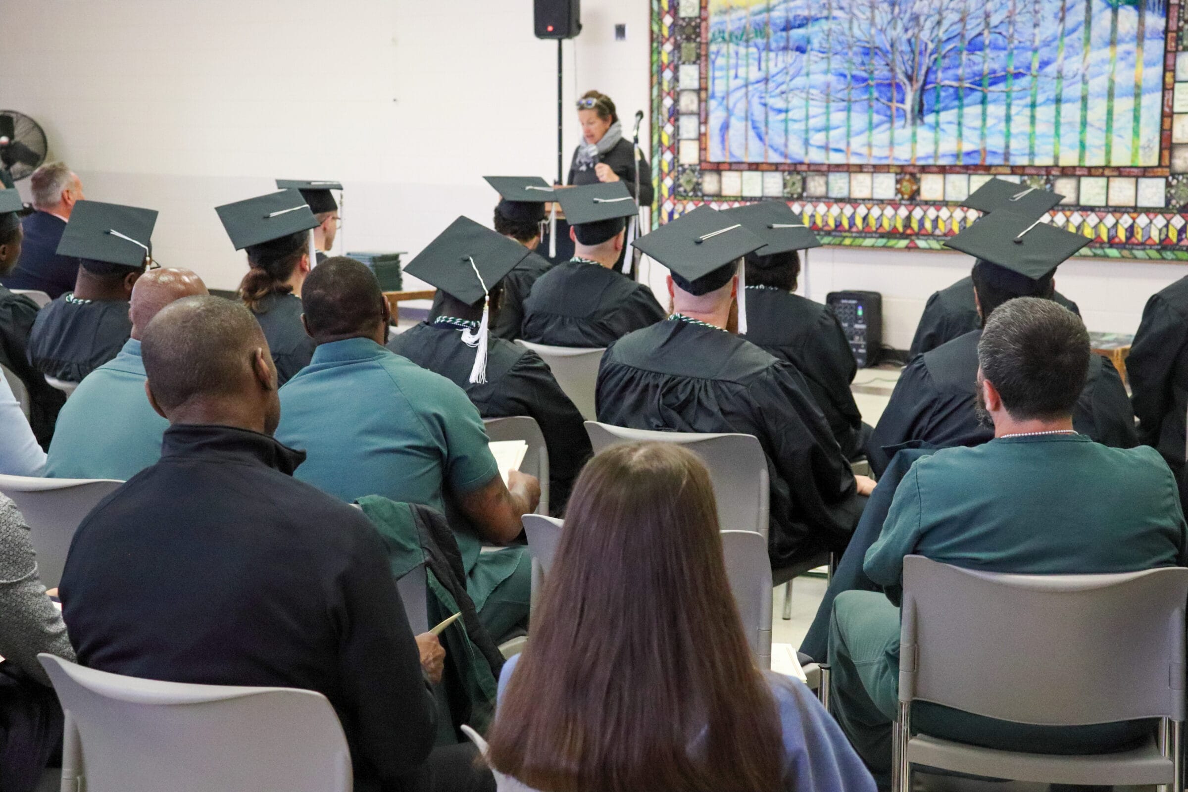 A group of incarcerated students attending their graduation ceremony