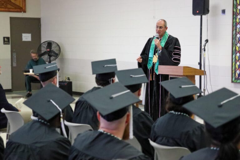 Greenbay Chancellor giving a speech to a graduating of incarcerated students