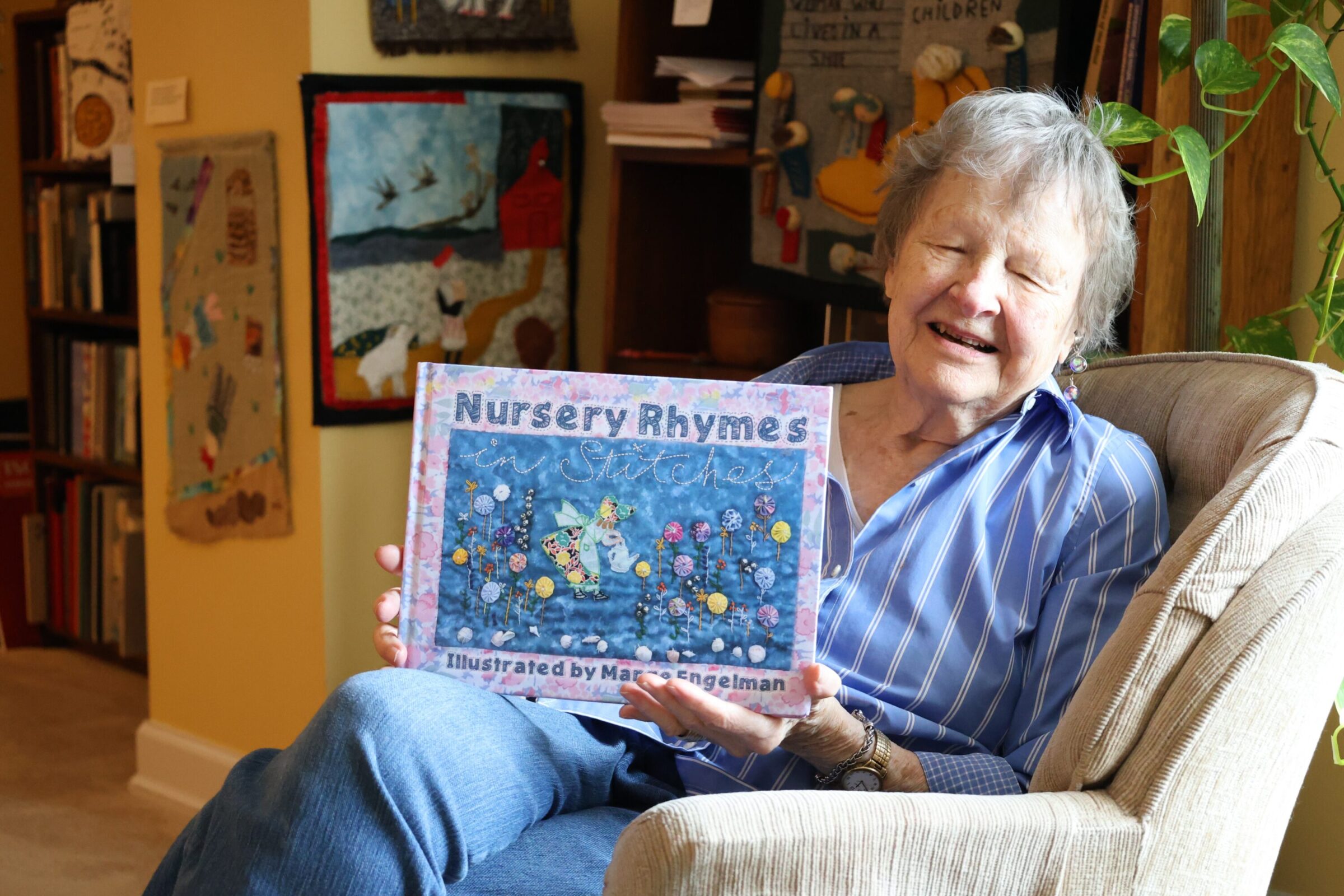 Marge Engelman holding up a book she published