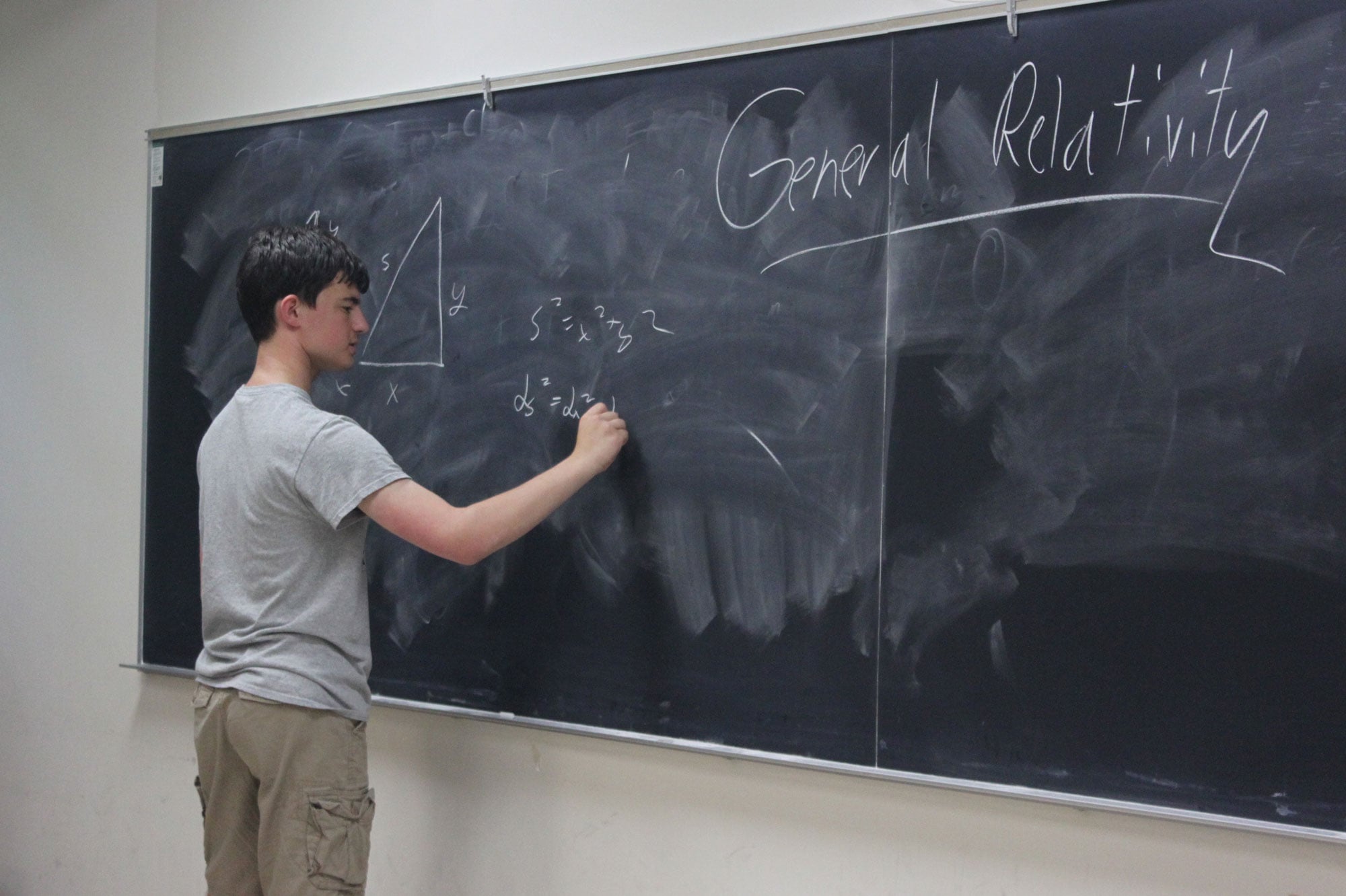 Nathan Wagner writing on a chalkboard