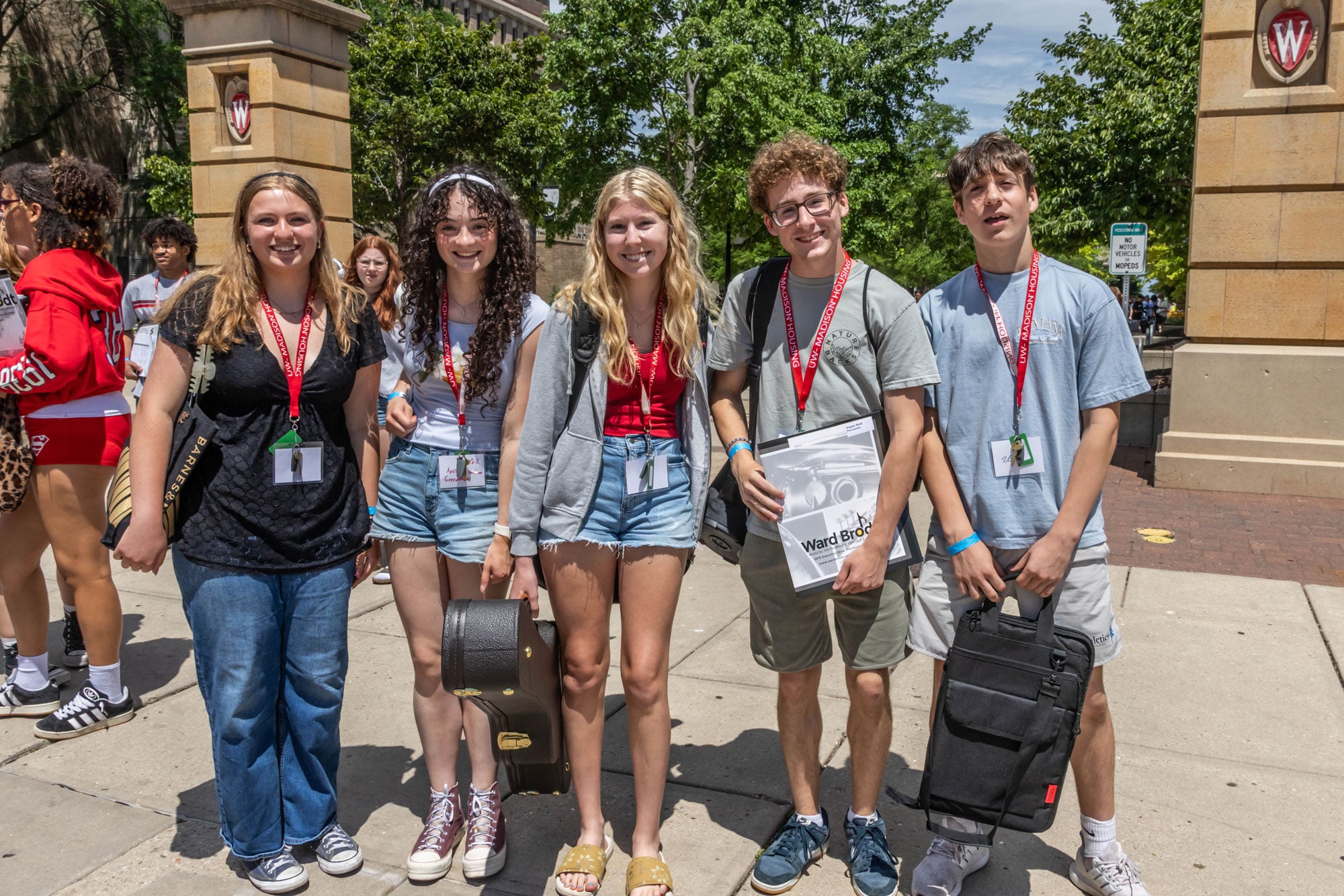 Five high school students in the UW–Madison Badger Precollege program walk together on campus.