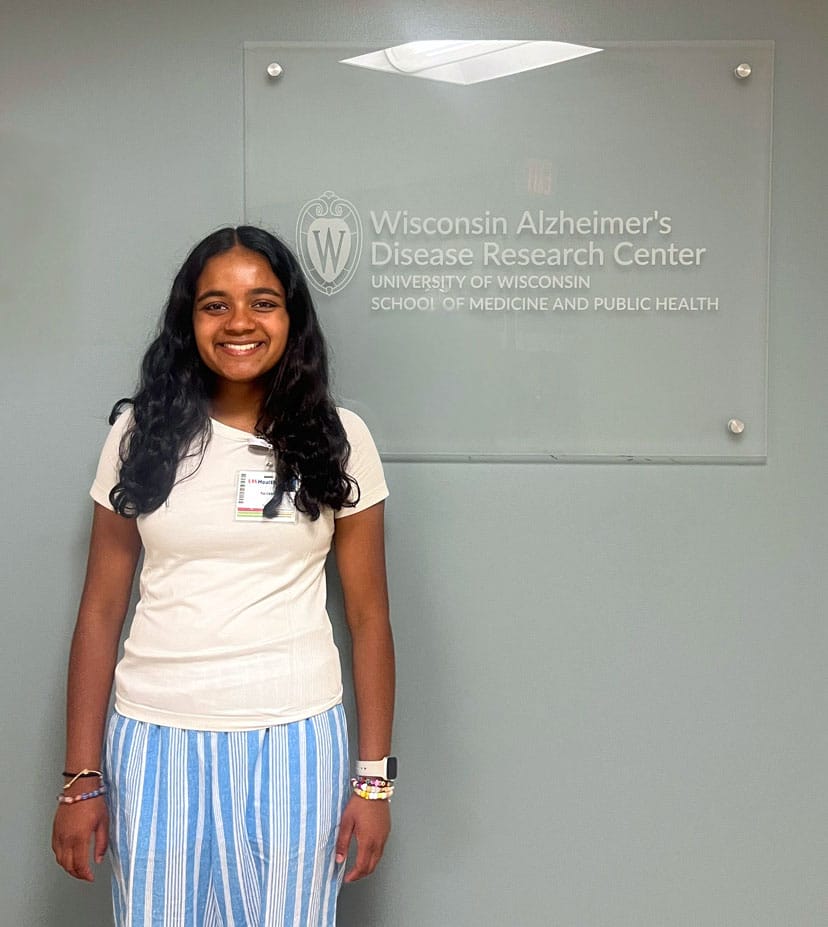 Naureen Kamal stands in front of a sign that reads Wisconsin Alzheimer’s Disease Research Center
