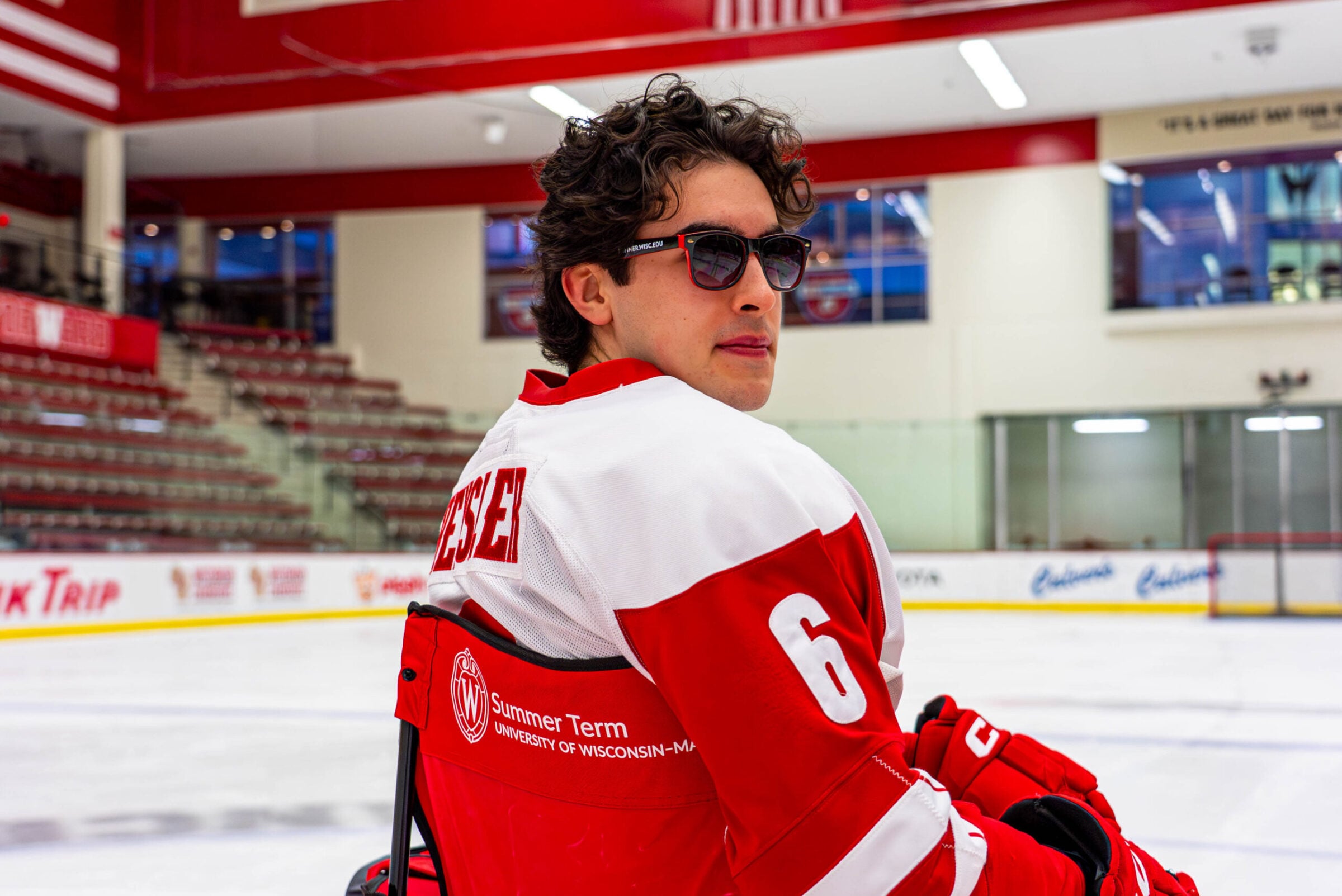 Logan Hensler poses for a picture sitting in a lawn chair and looking over his shoulder.