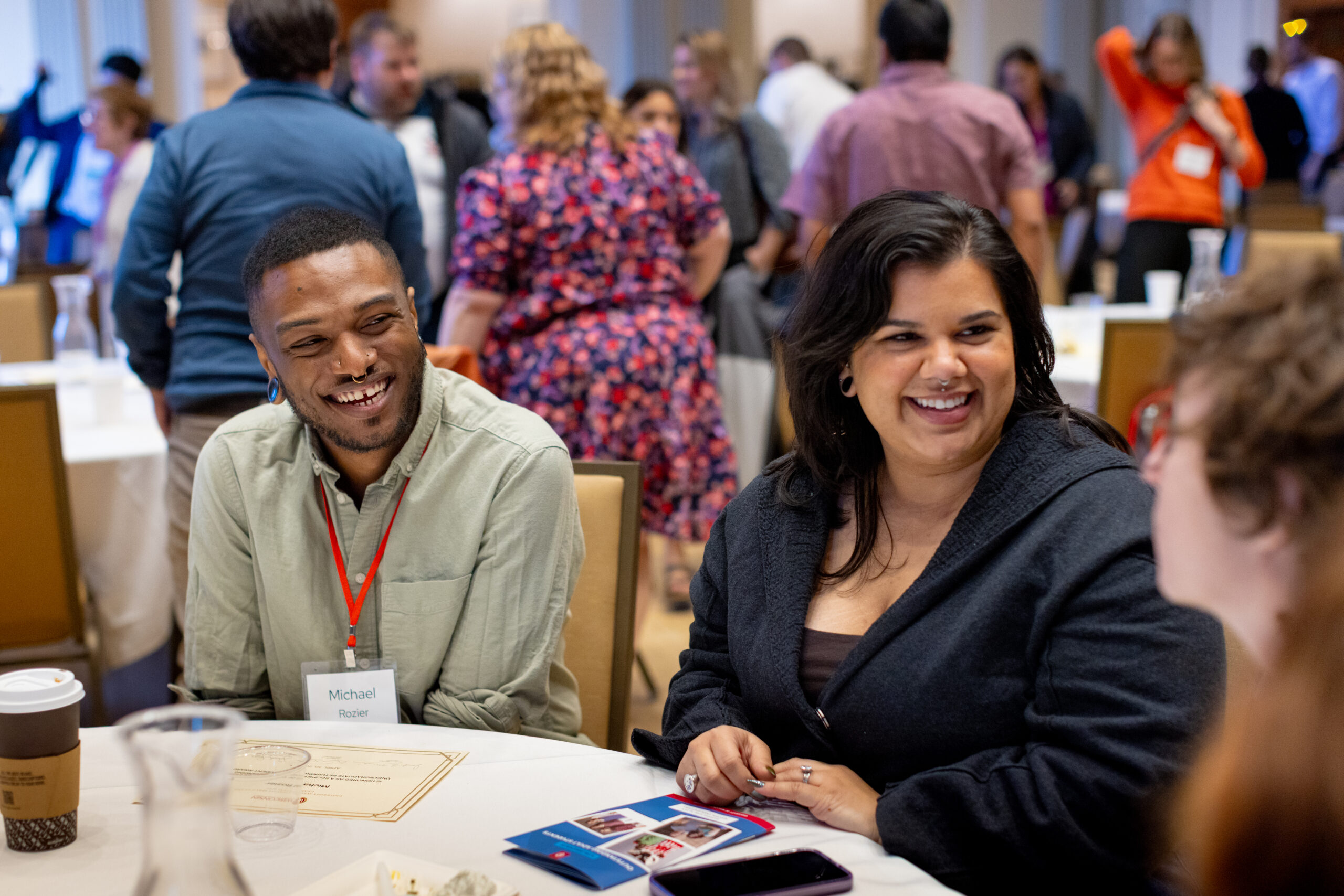 An adult student sitting next to his wife at the Outstanding Adult Student Reception.