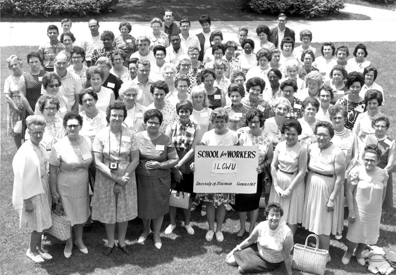 Group of women posing for a photo, holding a "School for Workers ILGWU" sign.