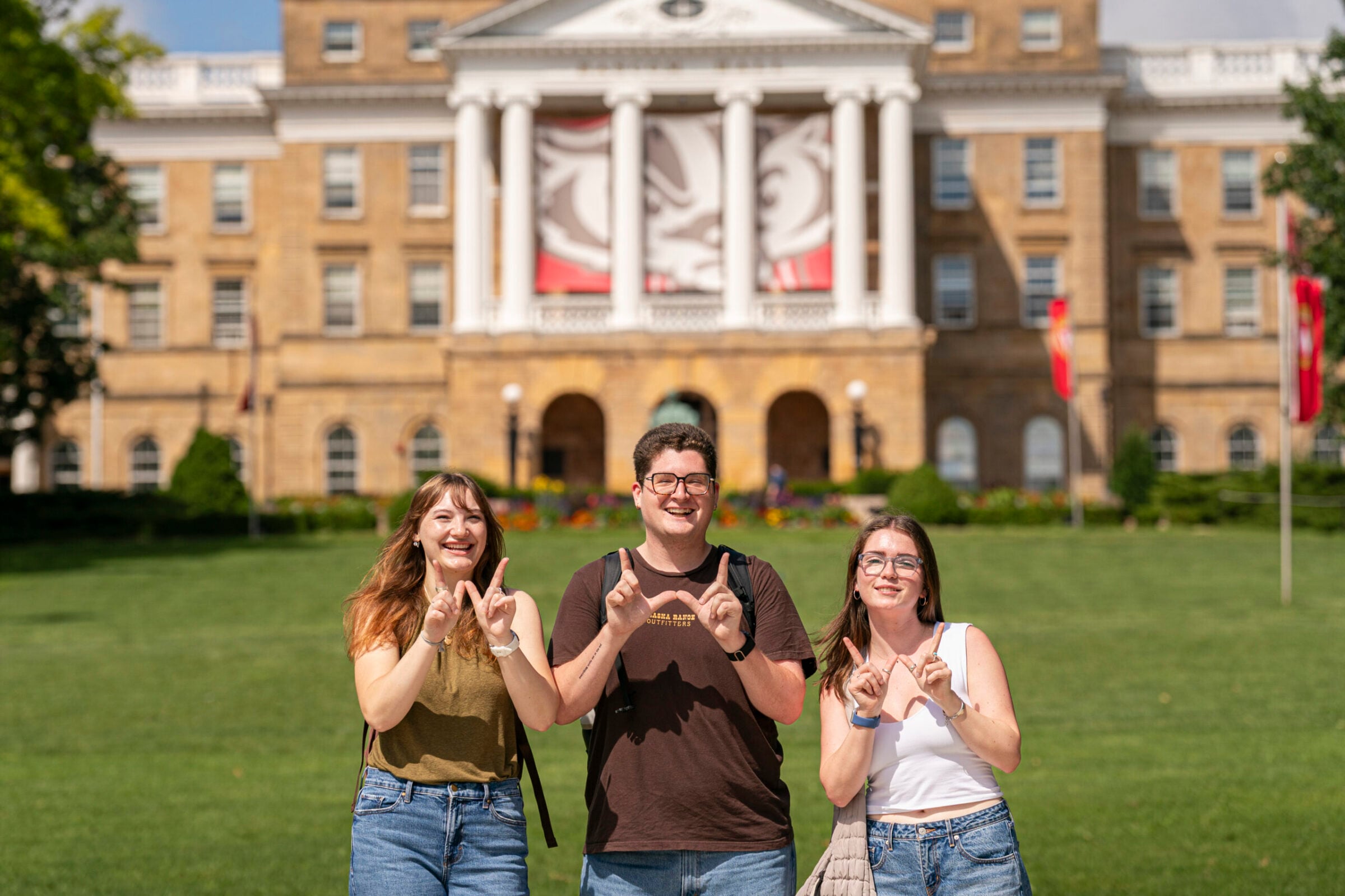 Three students on campus hill.