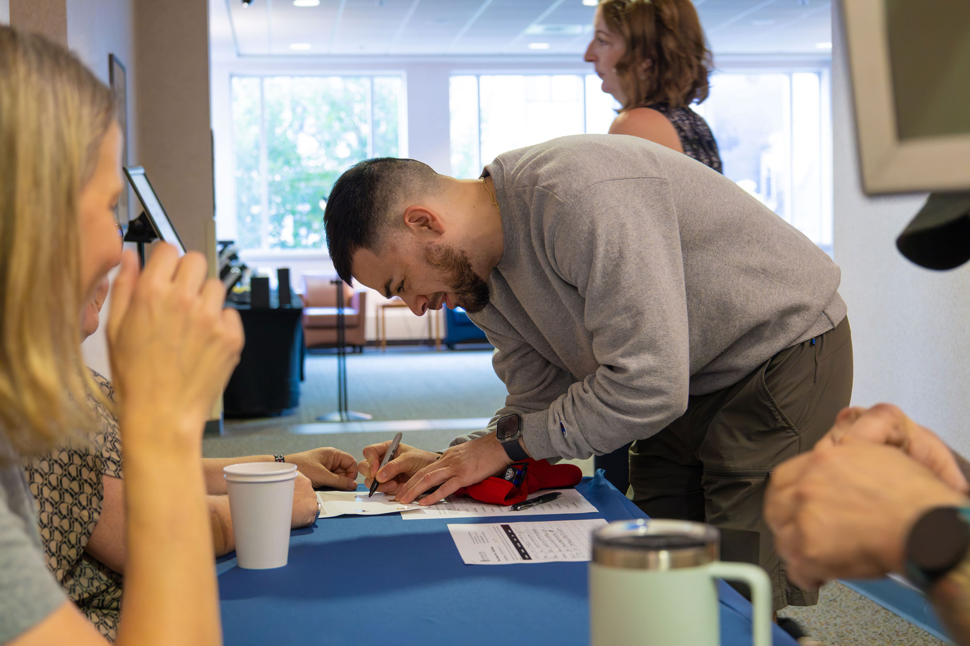 An atmosphere of nervous excitement filled the room as students signed in. Here, incoming student Jose Dracko Villarreal fills out his nametag before joining peers for introductions and a buffet breakfast.