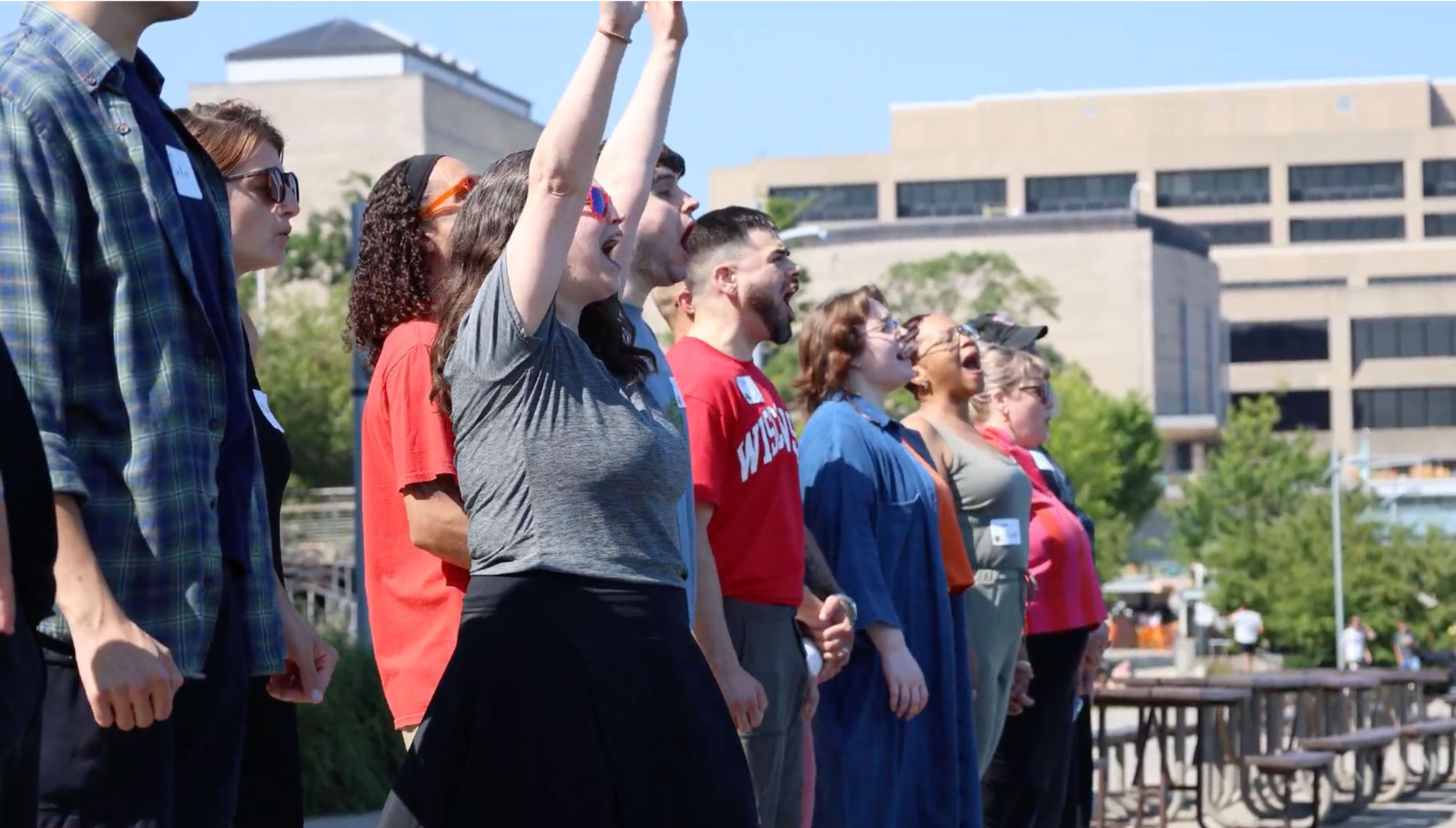 To break the ice and release first-day jitters, Badger Ready Advising Manager Autumn Sanchez (center, arms raised) led participants in a lakeside "scream club" at the Memorial Union Terrace.